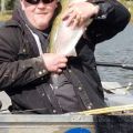 Mike Green of Doug Elliott hugging a fish 2018